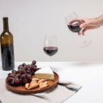 Clear Wine Glass Beside Brown Wooden Chopping Board With Sliced Bread and Wine Bottle