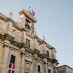 Facade of old building with flag of Dominican Republic