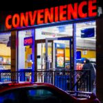A brightly lit convenience store at night, the kind of licensed retailer that fulfills tobacco delivery orders